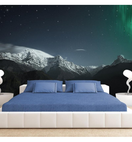 Fotobehang - Northern Lights - Snowy Mountain Landscape in Winter Night with Cosmos in the Background